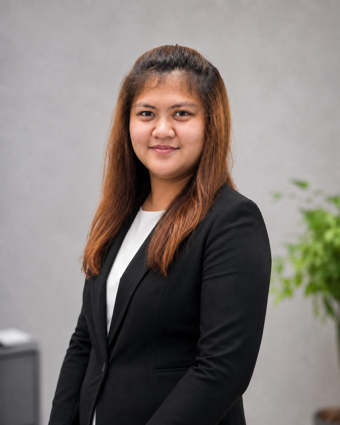Elysha smiling in a black blazer